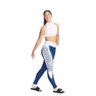 S-Line Leggings person wearing a white sports top and blue leggings with 'COUGARS' printed on the side, posing with one hand on her hip.