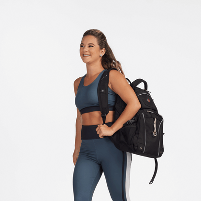 Model wearing teal blue S‑Line Trio Back sports bra with full front coverage and wide straps, paired with matching high-waist leggings—demonstrating athletic, routine-ready styling.