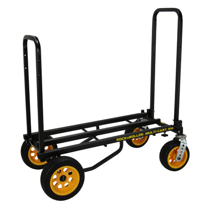 RocknRoller R18RT Mega Plus multi‑cart fully loaded with equipment; features aluminum frame with dual telescoping handles, two 18″ pneumatic rear wheels, two front swivel casters, and extra side braces—designed for hauling heavy gear across fields.