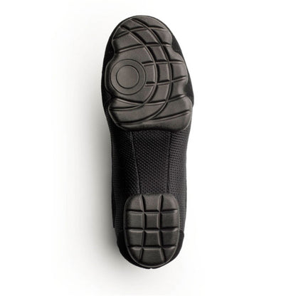 Sole view of Dinkles Accent guard shoe showing full rubber PU sole pads with sewn split‑sole pattern, circular pivot zone, and deep traction grooves for indoor/outdoor use