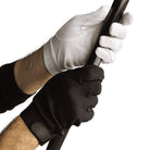 A person wearing black and white hook-and-loop sure grip gloves holding a baton.Pair of Dinkles Velcro Sure‑Grip gloves in black nylon, featuring full-finger coverage, palm-side Velcro strap at wrist for adjustable fit, and reinforced palm grip patches