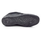 Sole view of Dinkles Spin showing smooth rubber split‑sole with pivot circle and segmented flex grooves for fluid spins and high-impact performance.